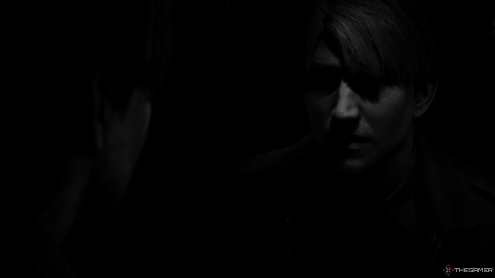 James looking at his reflection with the black and white filter applied in Silent Hill 2 remake.