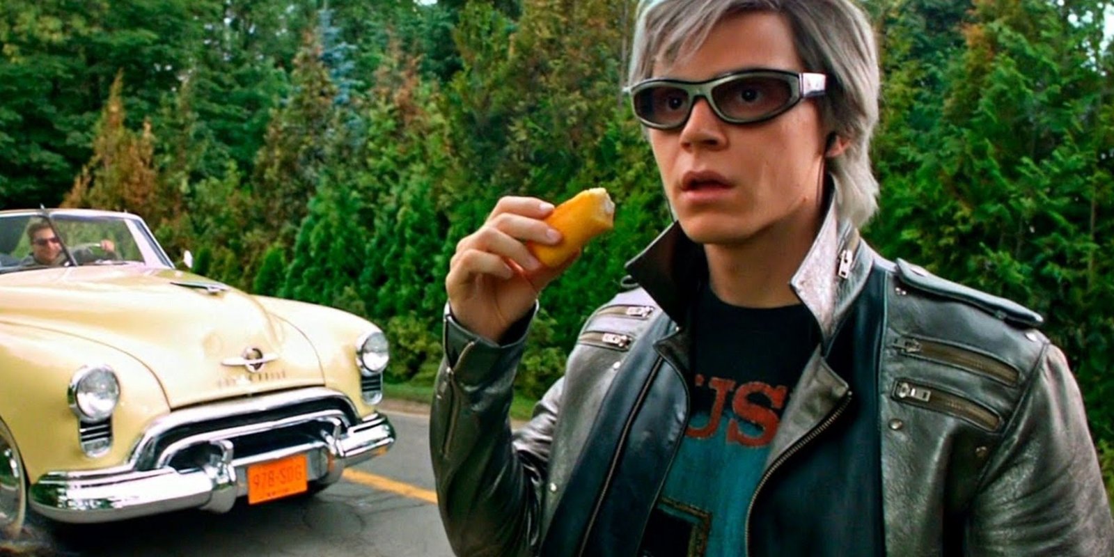 Quick Silver, played by Evan Peters, is eating a snack while looking shocked.