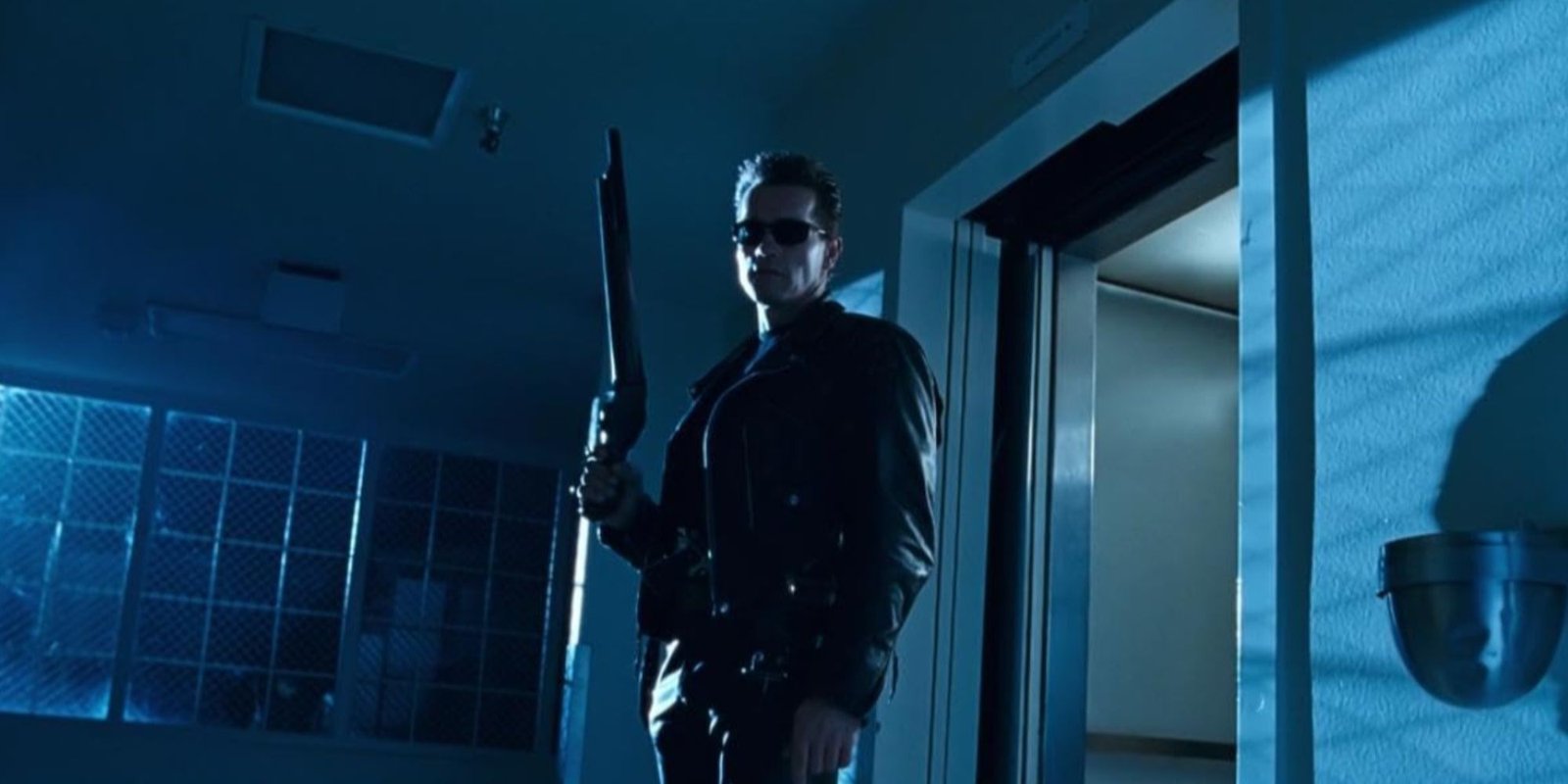James Cameron Embracing AI Is A Dark Moment For Hollywood Movies 1 Arnold Schwarzenegger's iconic Terminator character in leather jacket and sunglasses holding up a shotgun.