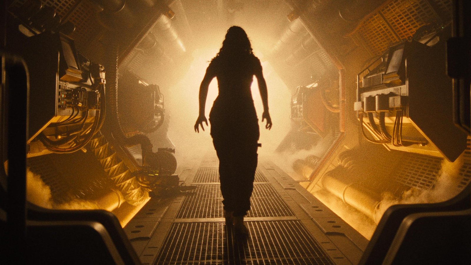 Romulus Didn’t Need To Bring Back Ian Holm 1 Alien Romulus woman walking down an orange-tinted corridor in a spaceship