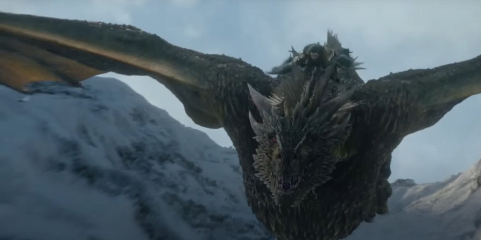 Jon Snow getting the grips of dragon riding as the majestic Rhaegal soars through the snow-capped mountains of the North.