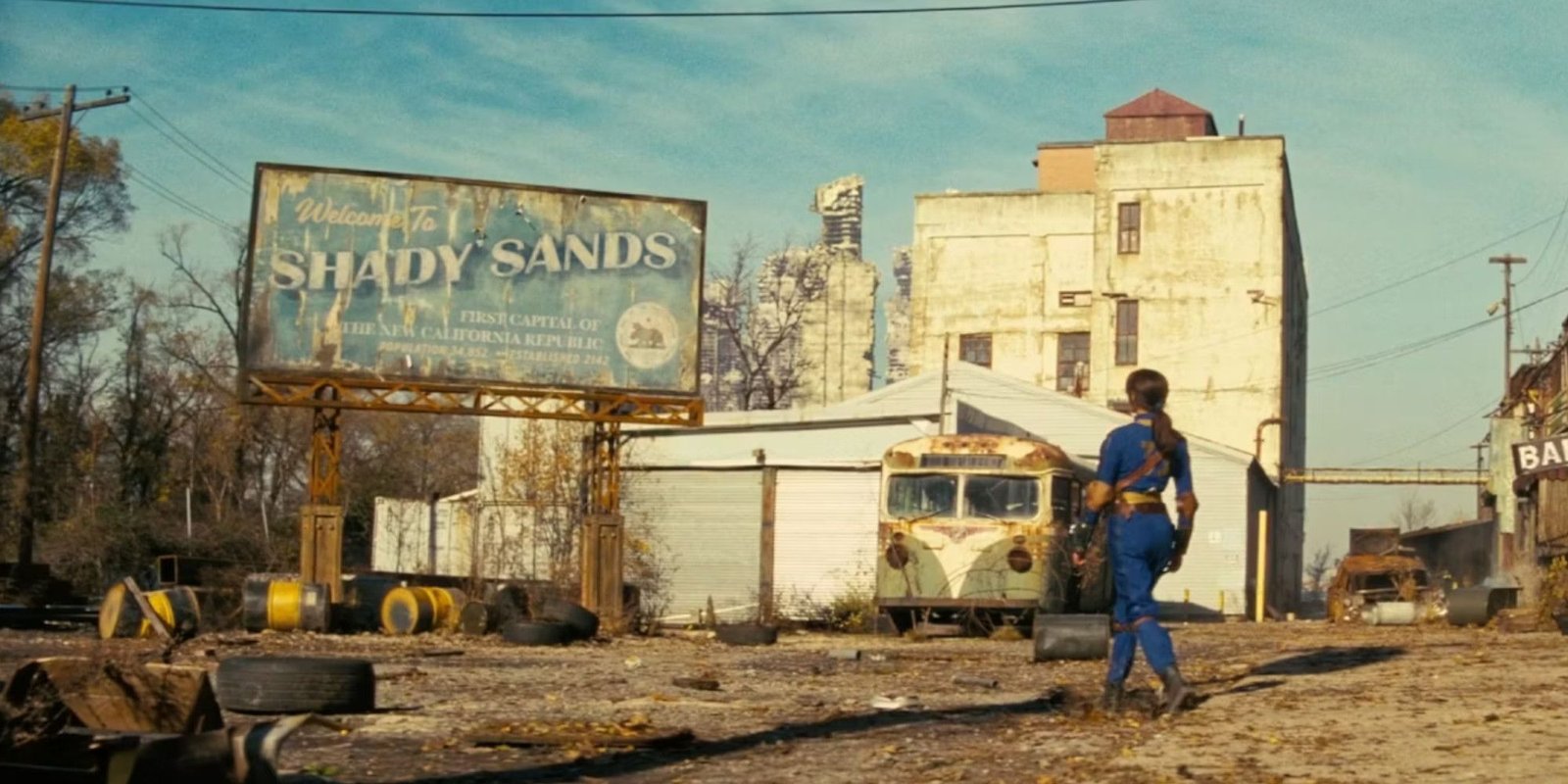 Fallout Show Reveals Who Dropped The Bombs First 2 Lucy walking towards a sign that says Shady Sands in Fallout
