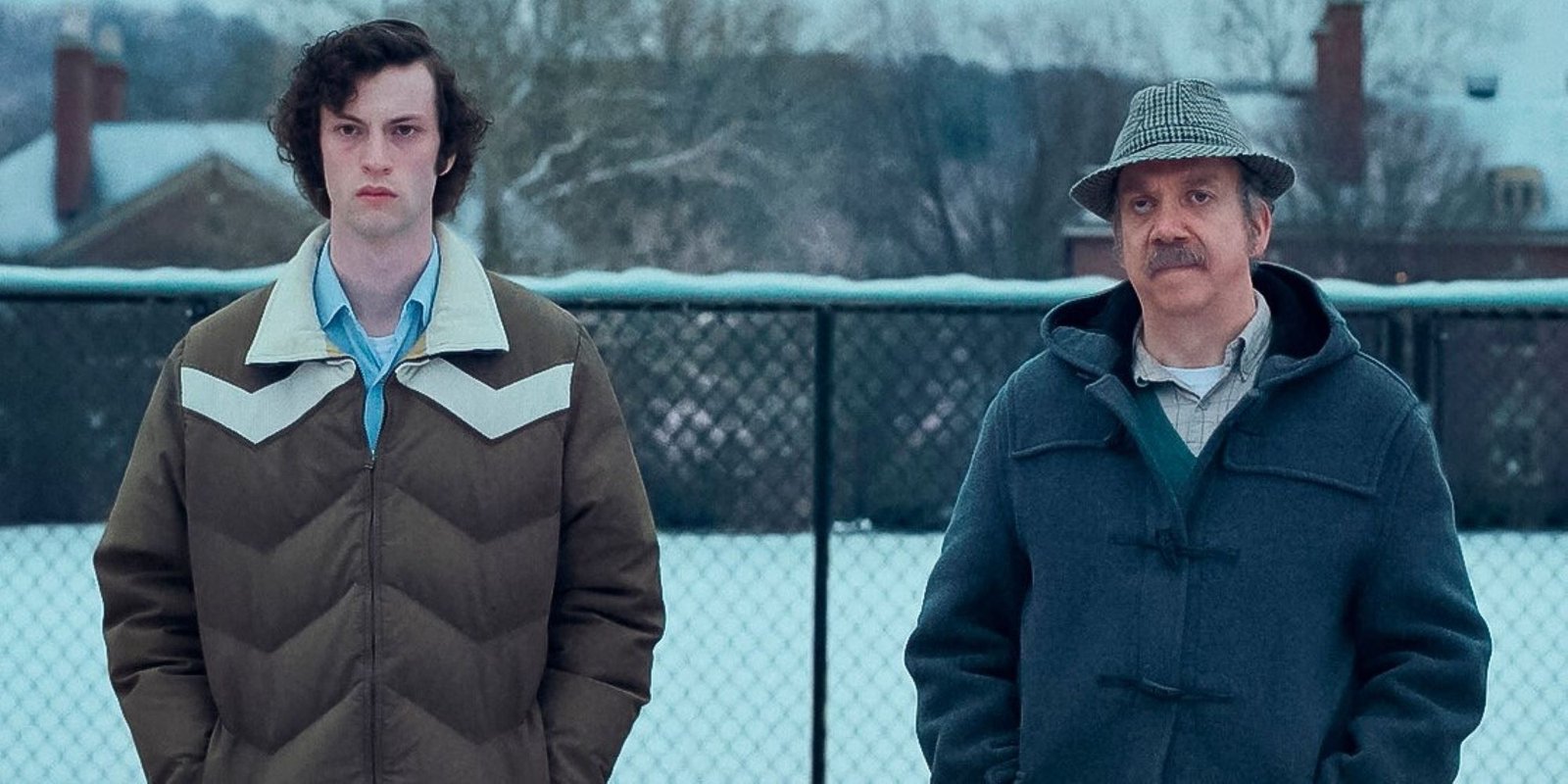 Dominic Sessa and Paul Giamatti in the snow in The Holdovers