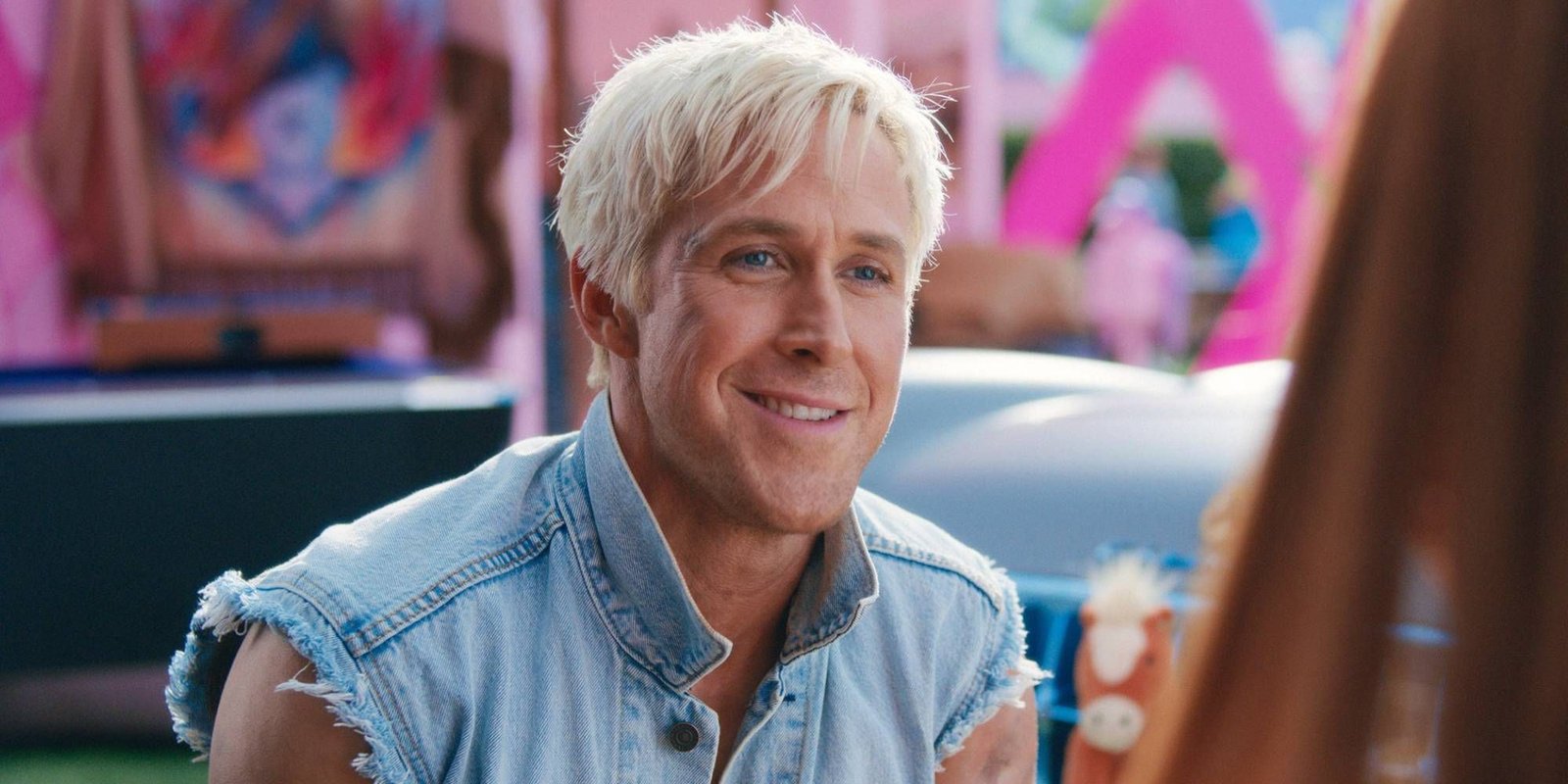 Ken smiling to someone off-camera in Barbie