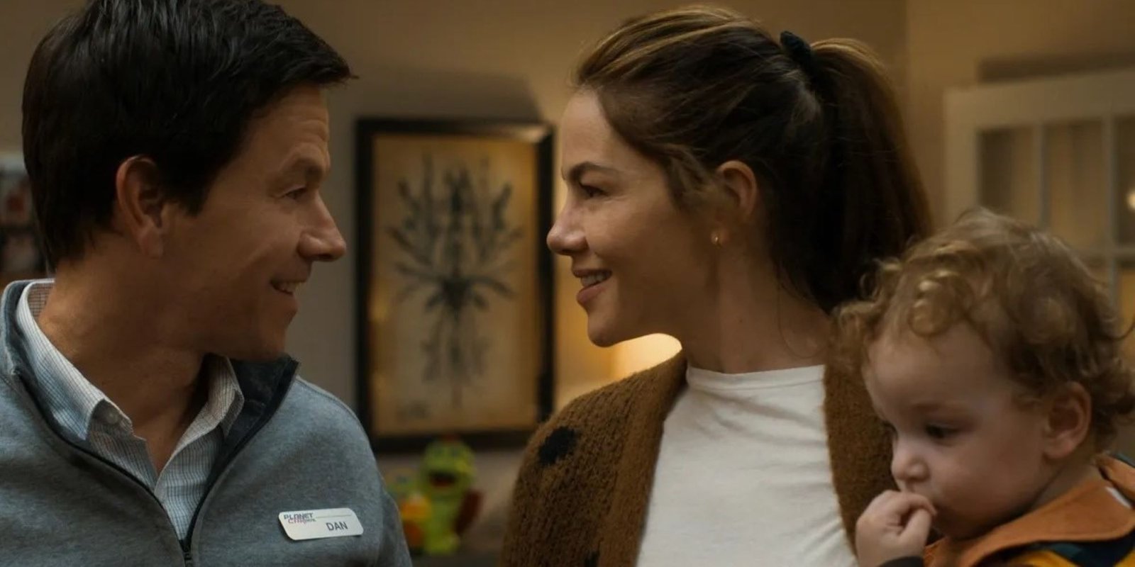 Mark Wahlberg and Michelle Monaghan smiling at each other in The Family Plan