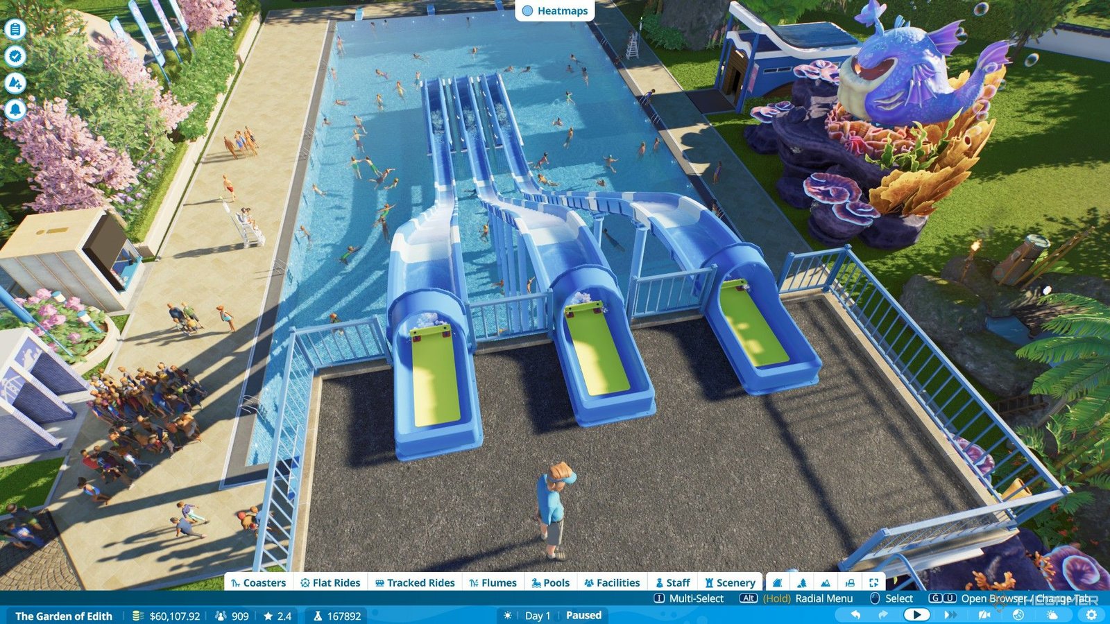 The player builds three flumes side by side to complete bronze objectives for Garden of Edith scenario in Planet Coaster 2.