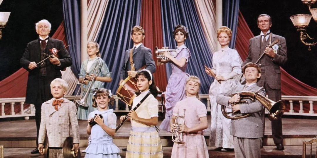 The cast of The One and Only, Genuine, Original Family Band stand with their instruments.