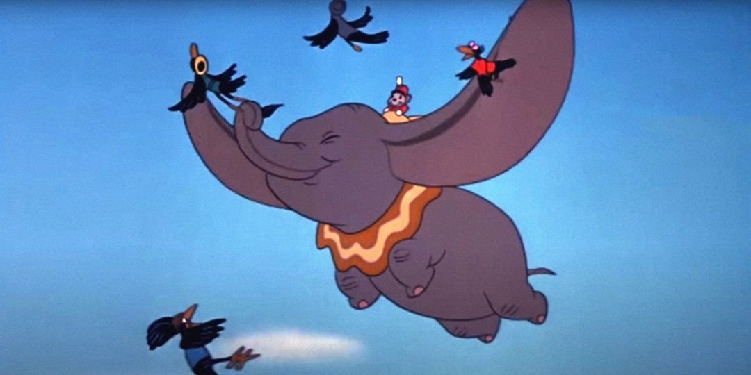 Dumbo flies in the air with the crows.