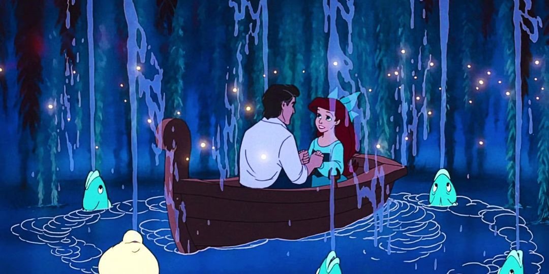 Eric and Ariel sit on a boat with fish spitting water around them.