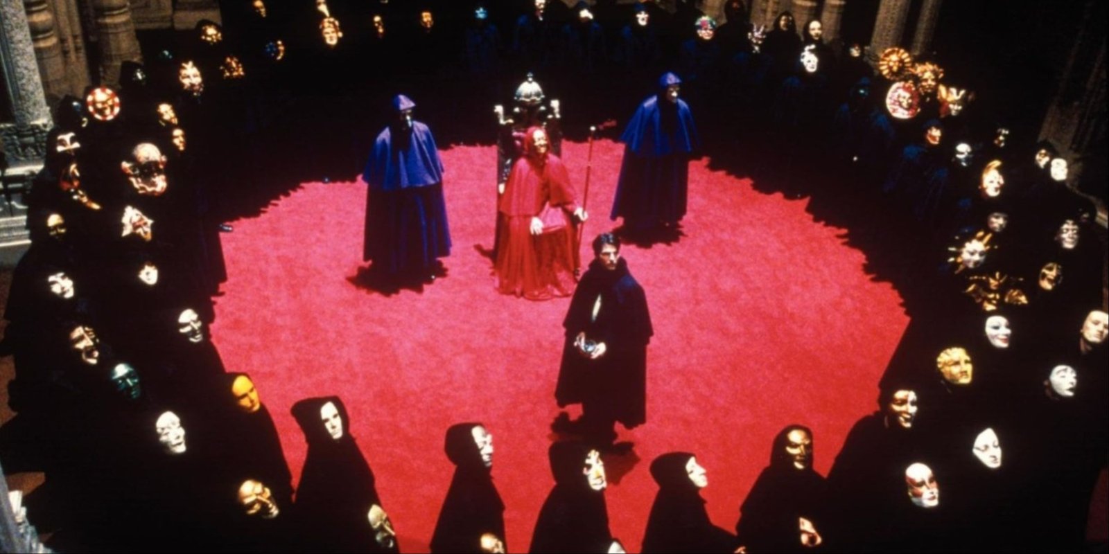 Tom Cruise surrounded by a sea of masked men at a secret society gathering in Eyes Wide Shut.