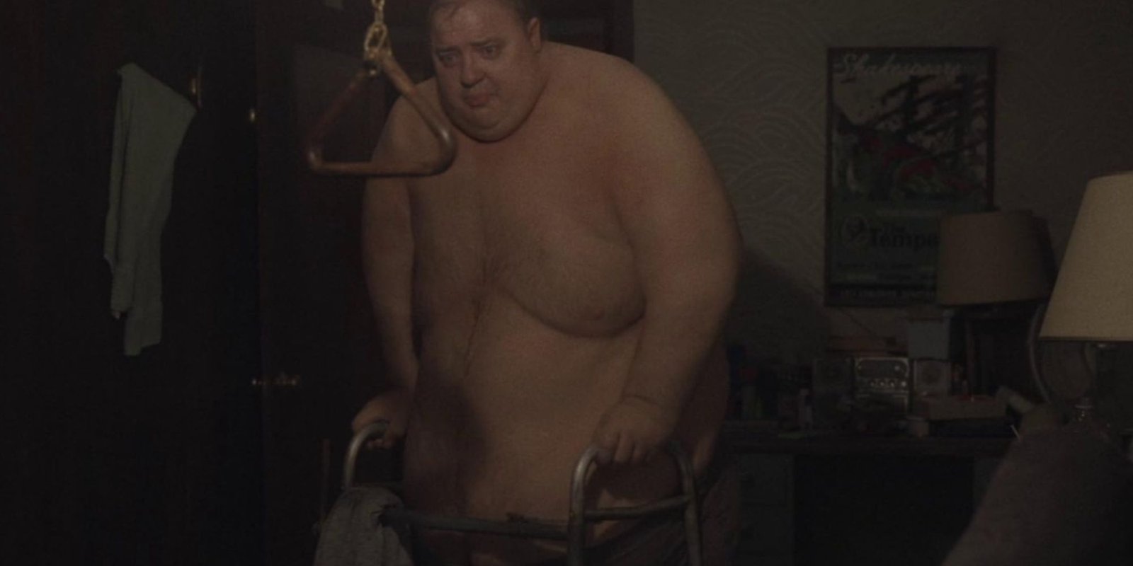 Brendan Fraser shirtless in the Oscar-winning prosthetics for The Whale trying to make it to his bed with a walker.