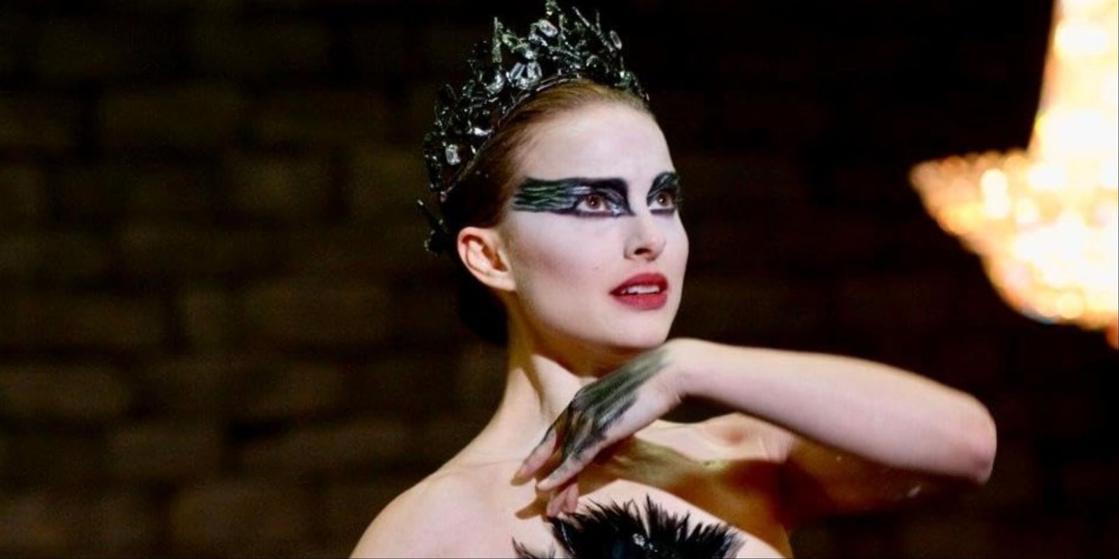 Natalie Portman in costume striking a pose as her character in Black Swan.