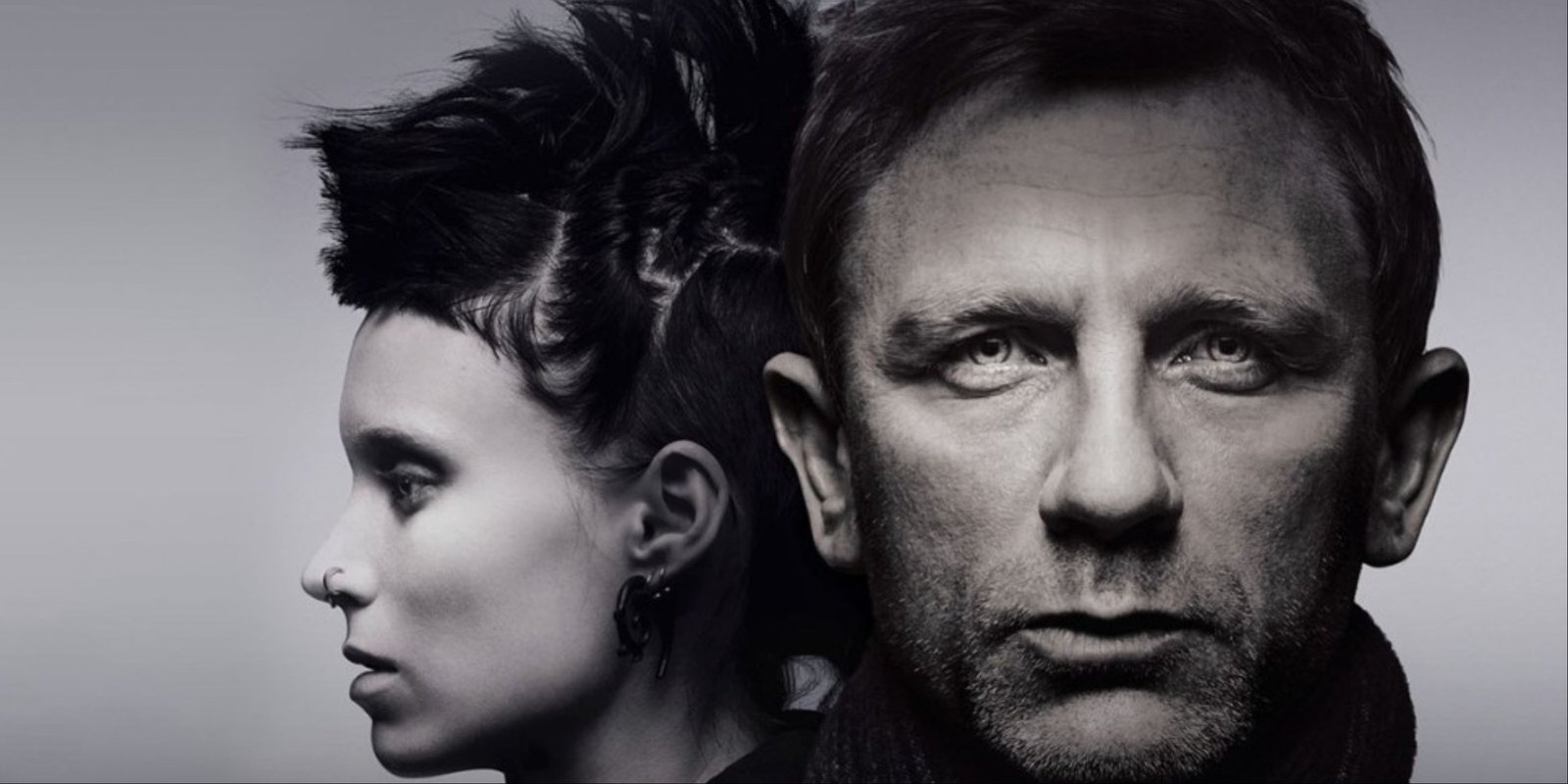 A close-up of Rooney Mara and Daniel Craig on the grayscale cover of The Girl with the Dragon Tattoo.