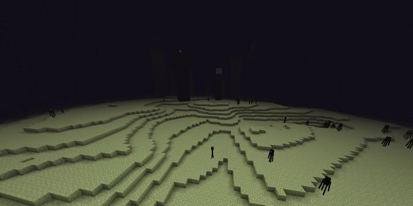 A player hovering above the Minecraft End dimension. 