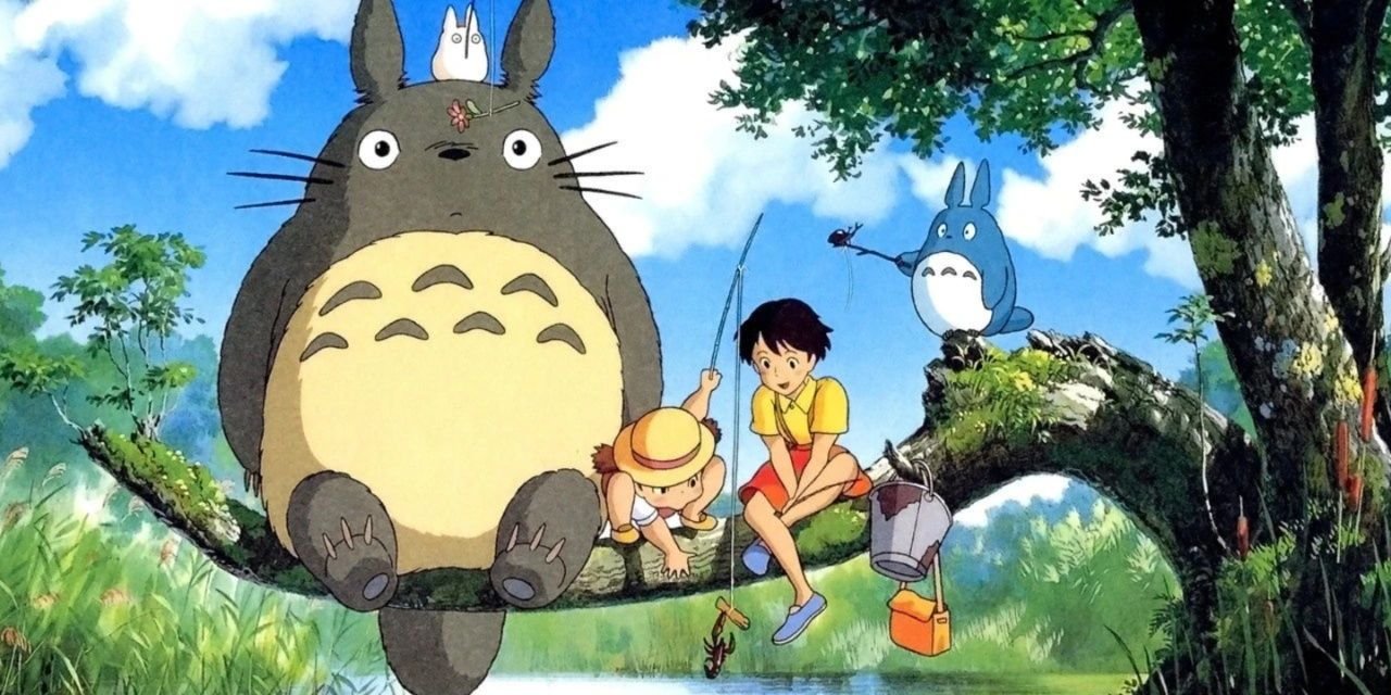 Totoro sitting atop a tree branch alongside some kids.