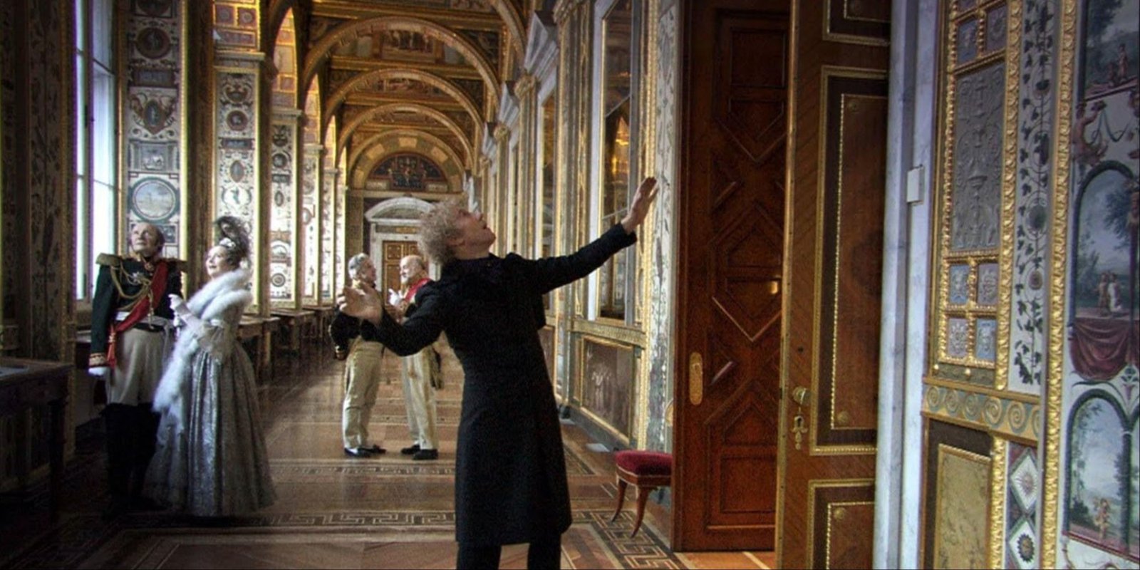 Sergey Dreyden's character dancing through a historical hall with figures from Russian history beside him in Russian Ark.