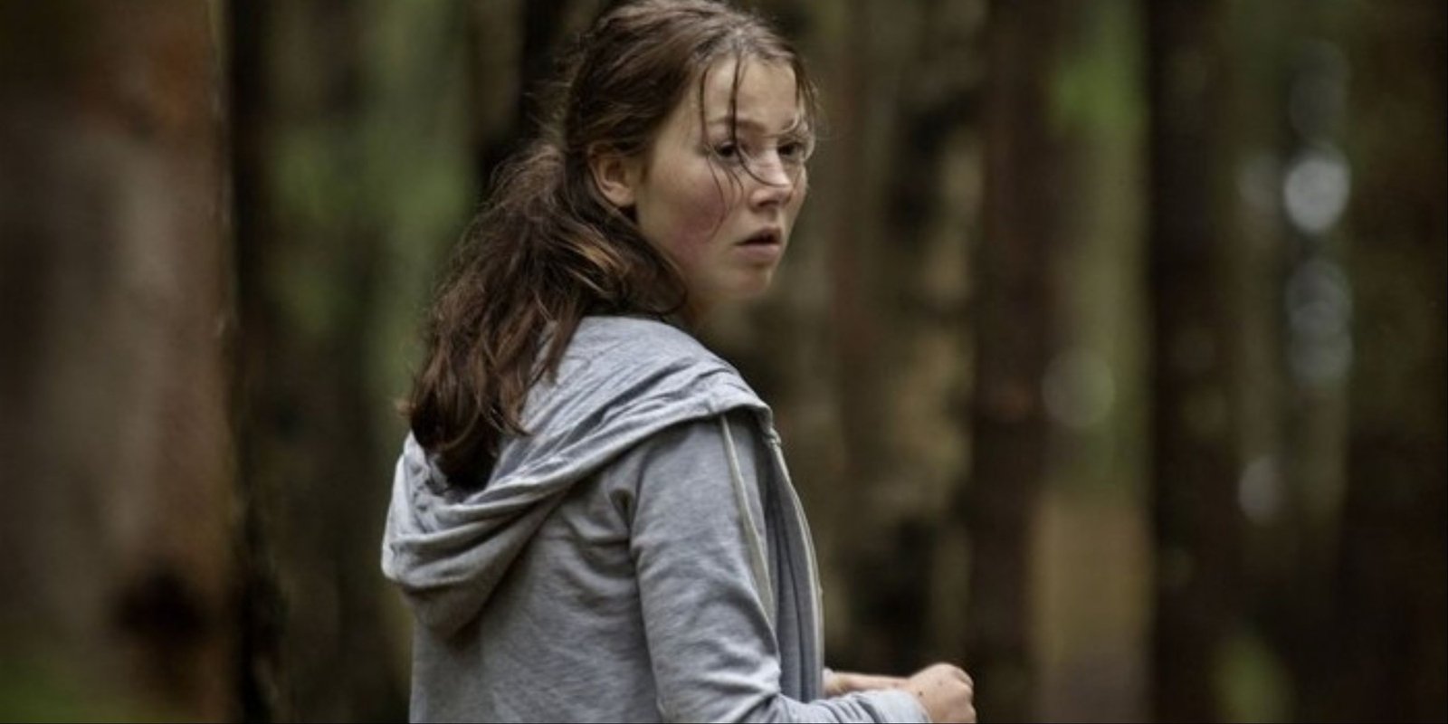 Andrea Berntzen's character looking back in distress through the woods in Utoya July 22.