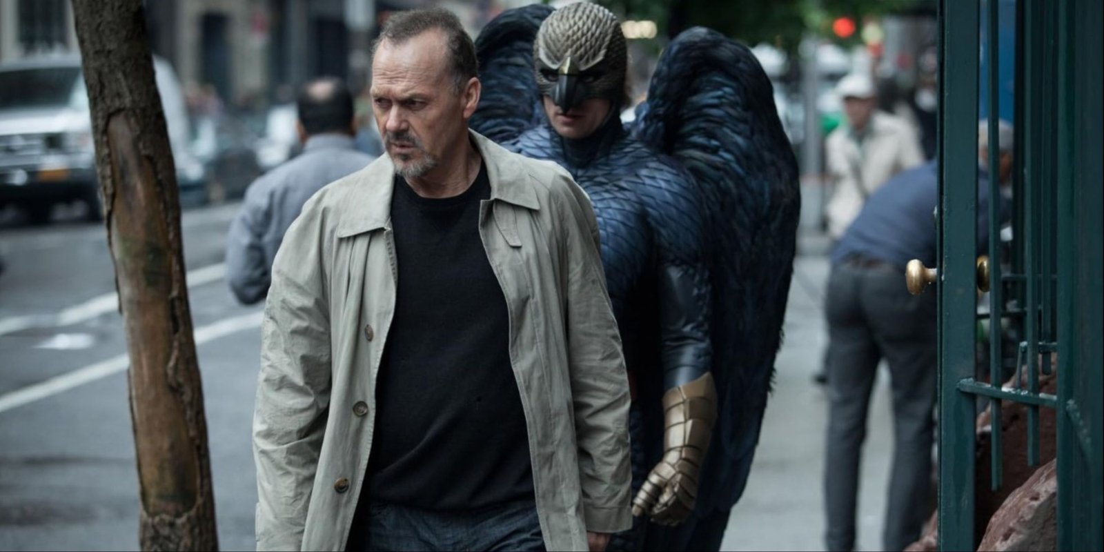 Michael Keaton walking in Birdman as the titular superhero walks behind him in Birdman.