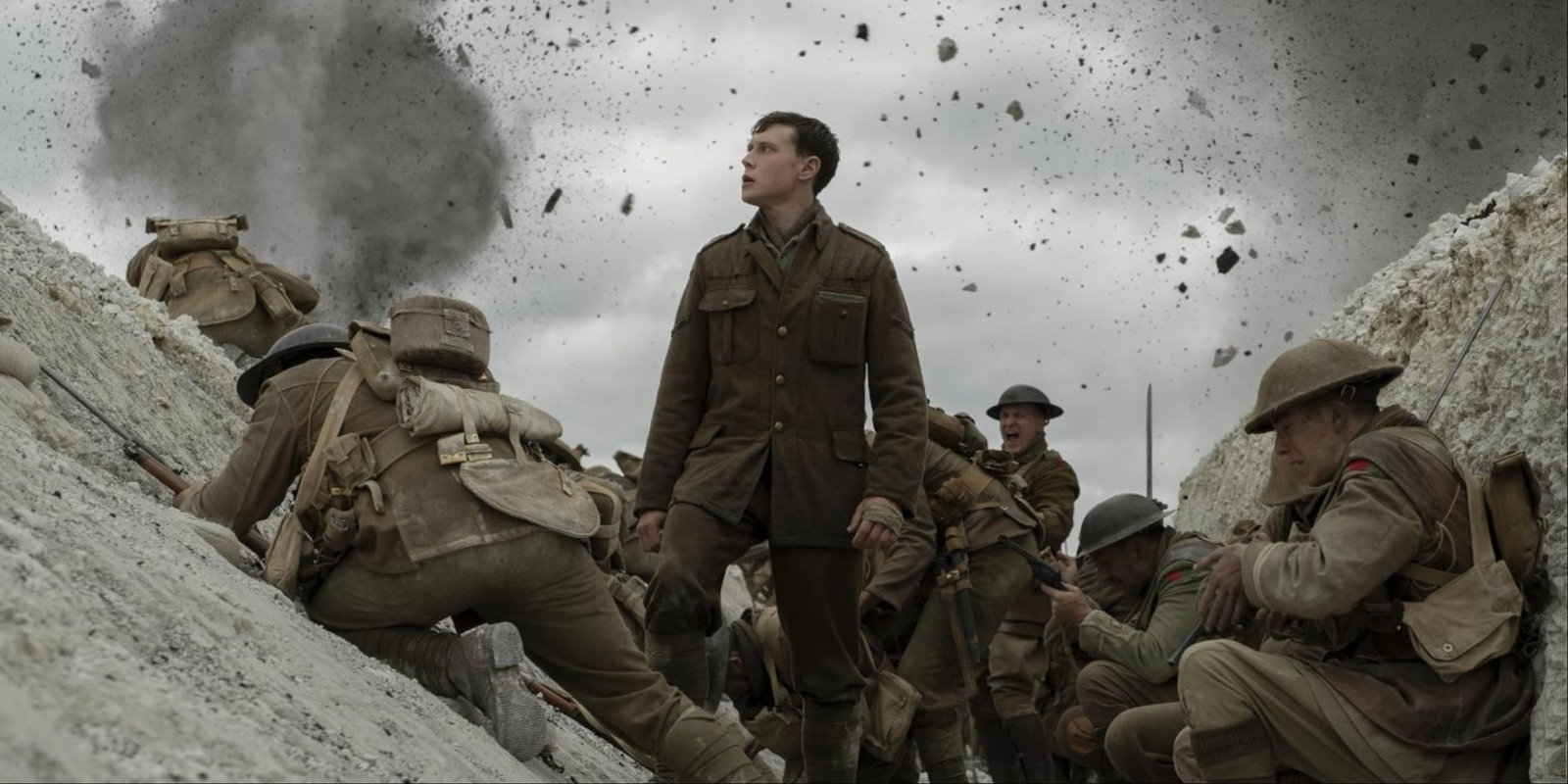 George MacKay in a trench as fellow soldiers are being struck with artillery in the iconic shot from 1917.