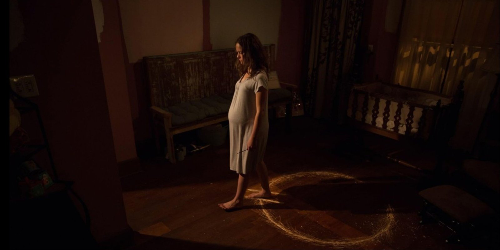 Allison Miller's pregnant Samantha walking out of a spirit trap circle in Devil's Due.