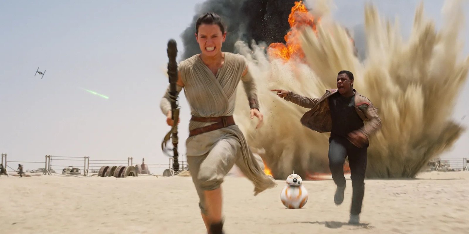 Rey and Finn running from TIE fighters in The Force Awakens.