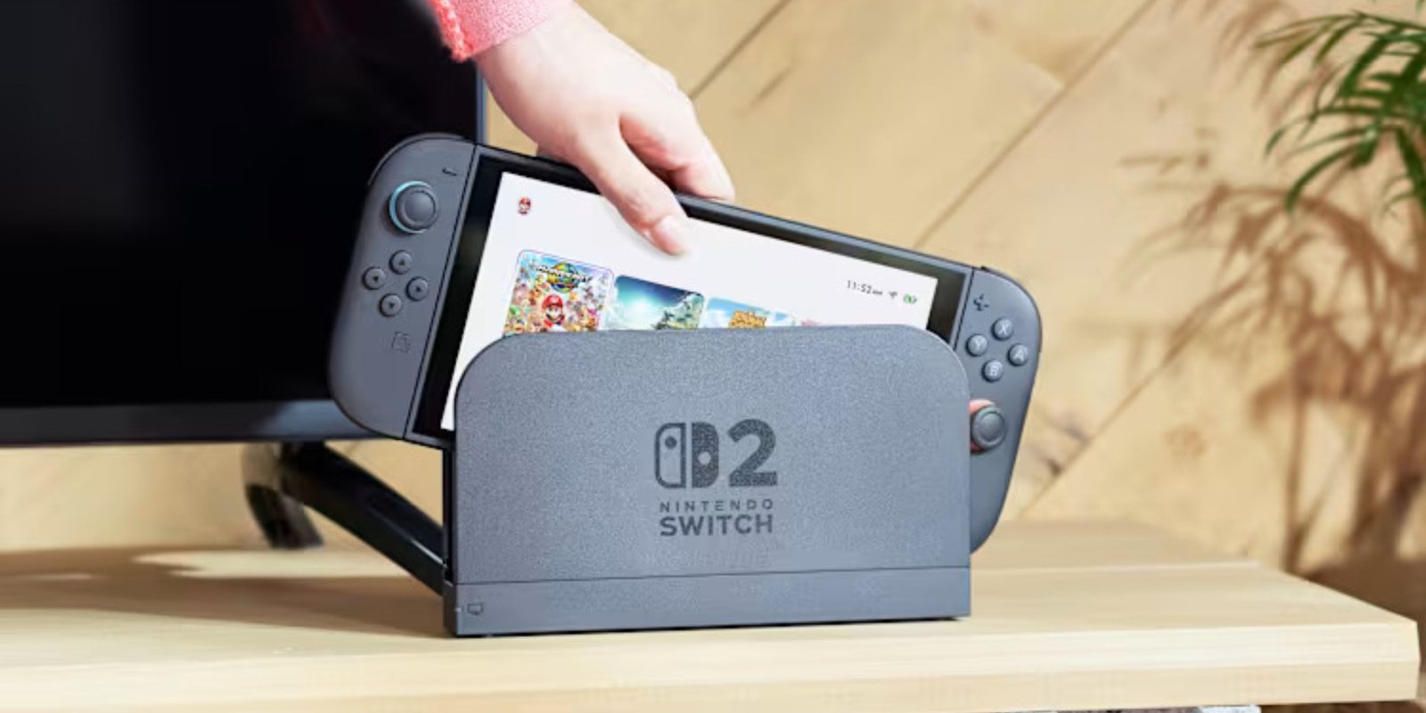 someone taking a switch 2 out of its dock.