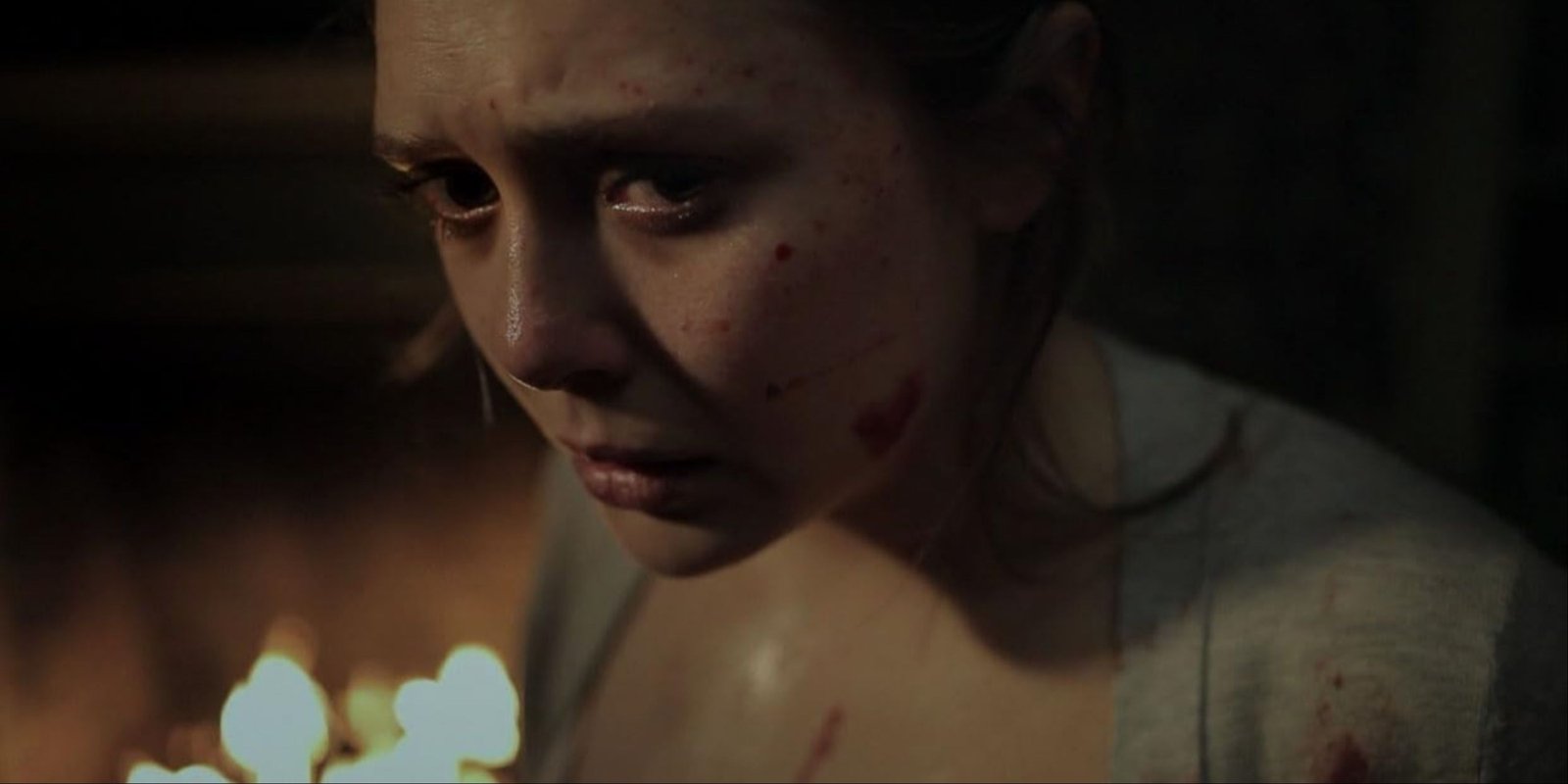 A close-up of Elizabeth Olsen covered in blood in the horror movie, Silent House.