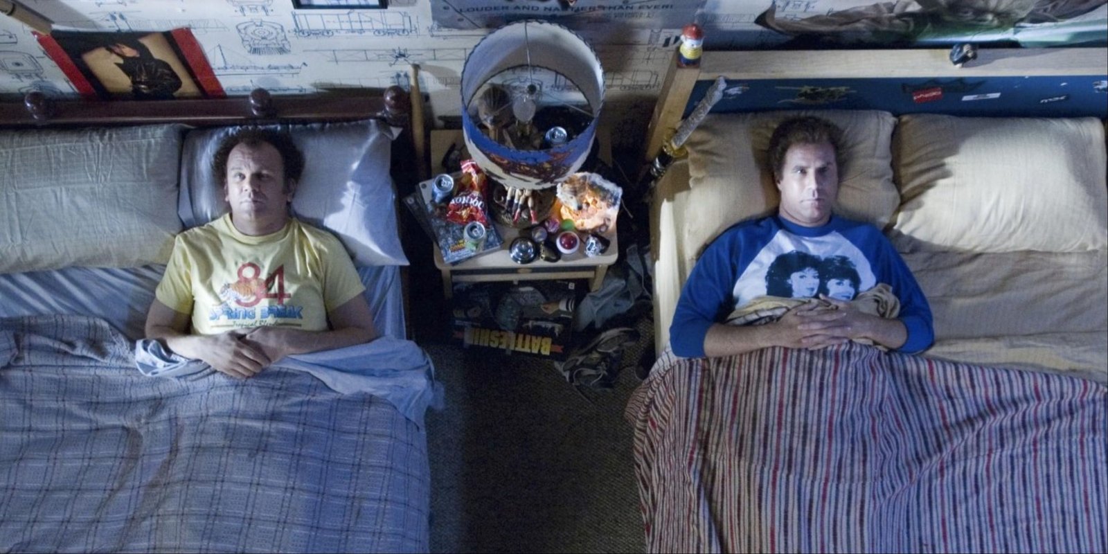 Dale and Brennan tucked in each other's separate beds and looking up at the ceiling as they talk in Step Brothers.