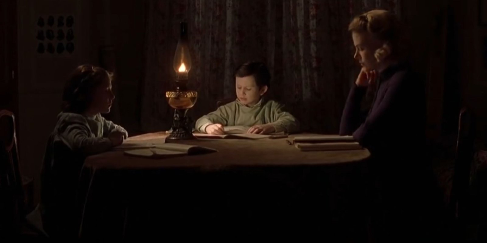 Grace watches her children as they read their books in The Others.