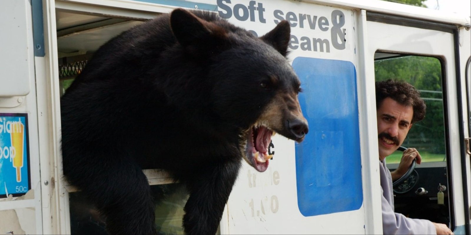 Sacha Baron Cohen ready to hit the road with a bear in an ice cream truck in Borat.