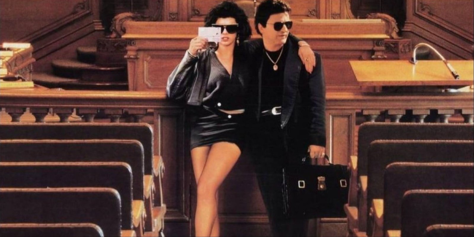 Marisa Tomei and Joe Pesci posing together in a courtroom on the main art of My Cousin Vinny.