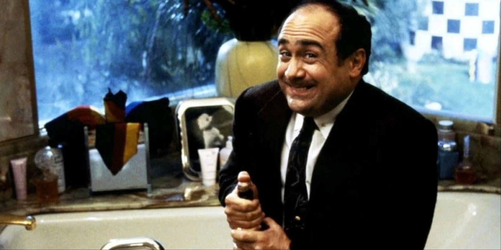 Dany DeVito looking all gleeful and popping champagne in Ruthless People.