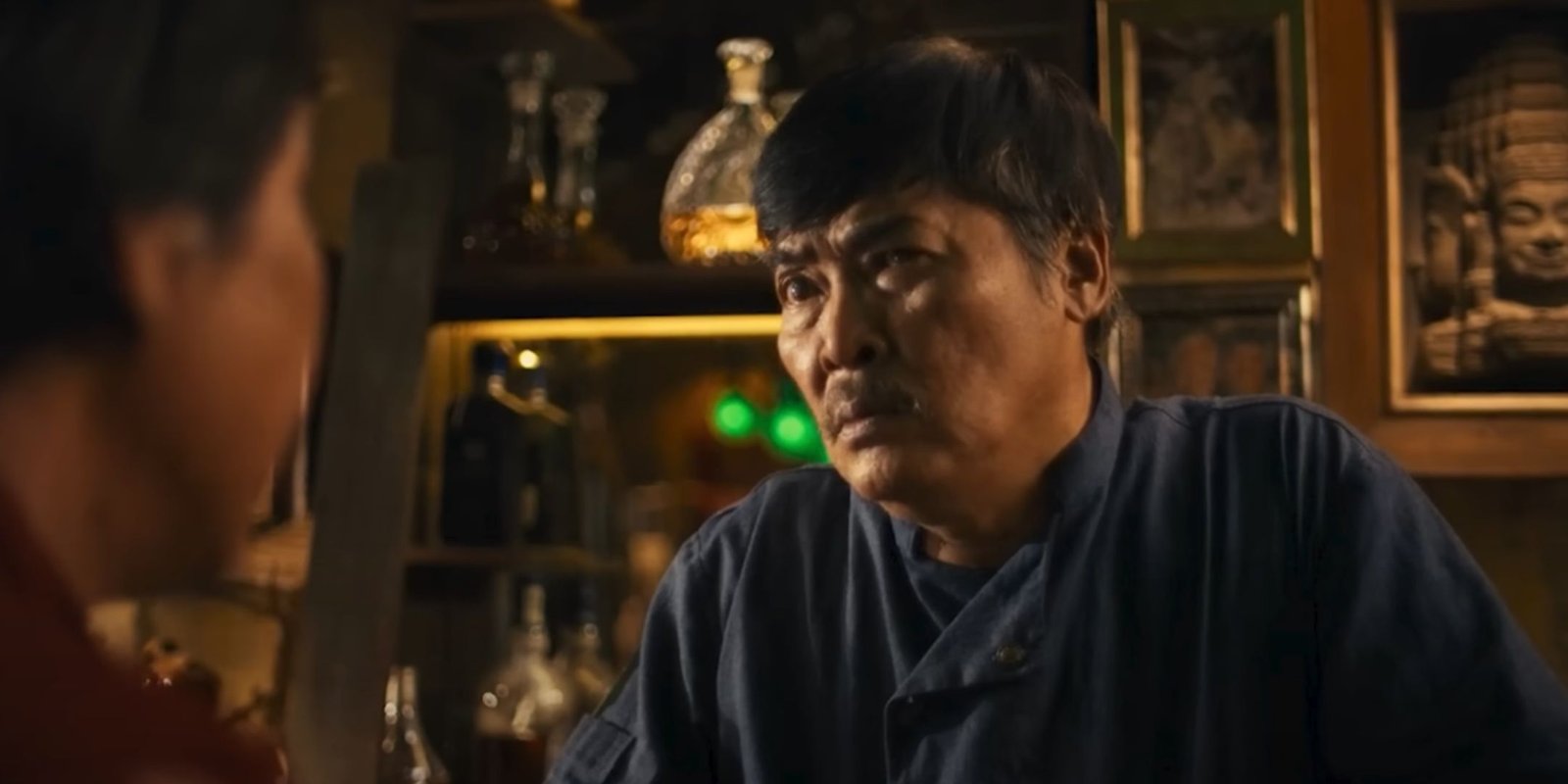 Huy, the diner owner, appears wary as he looks at his customer.