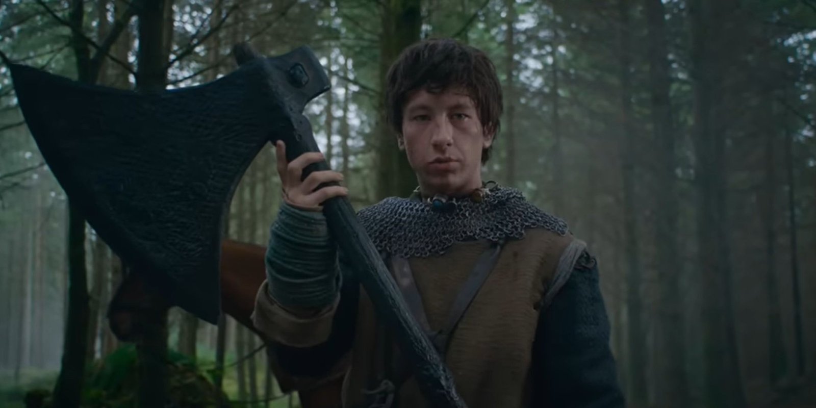 Barry Keoghan hoists a huge ax in The Green Knight.