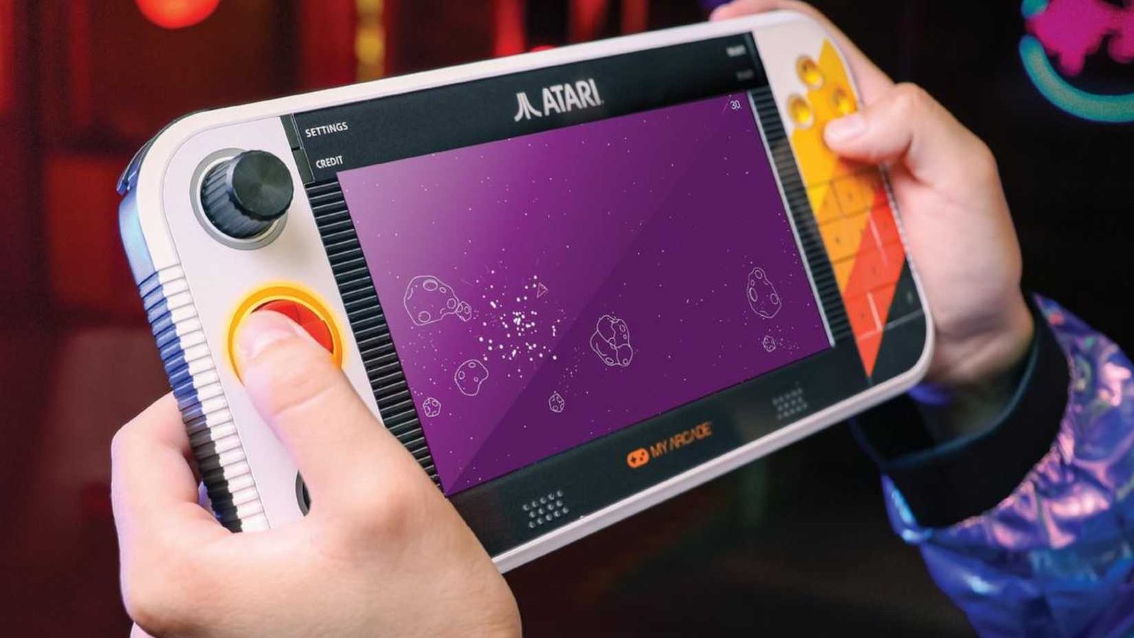 Someone playing asteroids on an atari gamestation go.